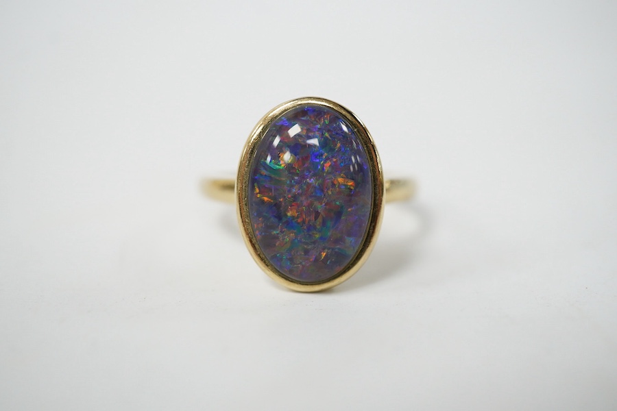 A modern 9ct gold and oval opal triplet set ring, size P/Q, gross weight 4 grams. Condition - good